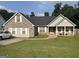Charming single-Gathering home with well-manicured lawn, inviting front porch, and traditional brick and siding exterior at 740 Pebble Blvd, Covington, GA 30016