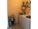 Functional laundry room with a washer, dryer, shelving, and storage space, making laundry chores efficient at 740 Pebble Blvd, Covington, GA 30016