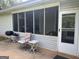 Relaxing screened porch featuring a chair and small table, ideal for enjoying outdoor living at 740 Pebble Blvd, Covington, GA 30016