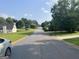 Scenic street view of a quiet neighborhood with well-maintained lawns and a variety of charming homes at 740 Pebble Blvd, Covington, GA 30016