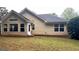 Rear view of home with a well-maintained lawn and siding at 155 Cottage Club Dr, Locust Grove, GA 30248