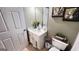 Neat half-bathroom featuring a single sink vanity, tile flooring, and neutral decor at 155 Cottage Club Dr, Locust Grove, GA 30248