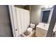 Cozy bathroom featuring neutral tones, a shower curtain, and a tiled floor at 155 Cottage Club Dr, Locust Grove, GA 30248
