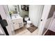 Well-lit bathroom featuring a white vanity, tile flooring, and a shower with a curtain at 155 Cottage Club Dr, Locust Grove, GA 30248