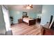 Spacious bedroom featuring a ceiling fan, light blue walls, and wood-look flooring at 155 Cottage Club Dr, Locust Grove, GA 30248
