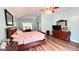 Tranquil bedroom with vaulted ceiling, a ceiling fan, and a decorative quilt on the bed at 155 Cottage Club Dr, Locust Grove, GA 30248