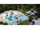 Aerial view of a resort-style community pool featuring water slides, splash pad, and ample seating for relaxation at 155 Cottage Club Dr, Locust Grove, GA 30248