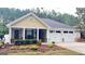 Charming home featuring a well-manicured front yard and a two-car garage at 155 Cottage Club Dr, Locust Grove, GA 30248