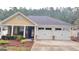 Charming home with a two-car garage, inviting porch, and well-kept landscaping at 155 Cottage Club Dr, Locust Grove, GA 30248