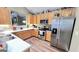 Well-lit kitchen featuring stainless steel appliances, light wood cabinets, and modern countertops at 155 Cottage Club Dr, Locust Grove, GA 30248