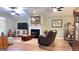 Spacious living room featuring a fireplace, wood floors, and an open layout at 155 Cottage Club Dr, Locust Grove, GA 30248