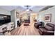 Open-concept living room showcasing hardwood floors and a cozy fireplace at 155 Cottage Club Dr, Locust Grove, GA 30248