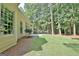 Spacious backyard featuring a patio, lush lawn, and a tranquil wooded backdrop, perfect for outdoor enjoyment at 185 Newfield Dr, Tyrone, GA 30290