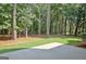 Tranquil backyard with mature trees and a patio at 185 Newfield Dr, Tyrone, GA 30290
