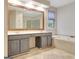 A Primary bath featuring a bathtub, dual sinks, a vanity, and tile flooring at 185 Newfield Dr, Tyrone, GA 30290