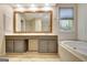 Bathroom featuring dual sinks and a bathtub at 185 Newfield Dr, Tyrone, GA 30290