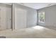 Neutral bedroom features a closet, window, and wall-to-wall carpet creating a comfortable and inviting space at 185 Newfield Dr, Tyrone, GA 30290