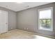 Bright, neutral bedroom features carpet, a window with blinds, and a closet for storage at 185 Newfield Dr, Tyrone, GA 30290