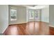 Sun-filled bedroom boasting hardwood floors and large windows overlooking the yard at 185 Newfield Dr, Tyrone, GA 30290