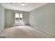Bright bedroom with plush carpeting, large window, and natural light at 185 Newfield Dr, Tyrone, GA 30290