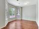A bedroom with hardwood floors and lots of natural light from the large bay windows at 185 Newfield Dr, Tyrone, GA 30290
