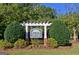 Elegant community sign set amidst lush landscaping, creating an inviting entrance that adds to the neighborhood's appeal at 185 Newfield Dr, Tyrone, GA 30290