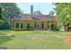 Exterior of a home with a spacious backyard, patio, and wooded backdrop, perfect for outdoor living and entertaining at 185 Newfield Dr, Tyrone, GA 30290