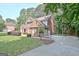 Beautiful brick home with a spacious driveway, three-car garage, and well-maintained lawn at 185 Newfield Dr, Tyrone, GA 30290