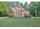 Beautiful red brick home with manicured landscaping and charming curb appeal at 185 Newfield Dr, Tyrone, GA 30290