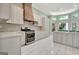 Bright kitchen featuring custom white cabinets, modern appliances, and tile flooring at 185 Newfield Dr, Tyrone, GA 30290