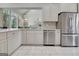 Modern kitchen with stainless steel appliances, white cabinets, and a view to the breakfast area at 185 Newfield Dr, Tyrone, GA 30290