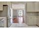 Kitchen with a view to living area featuring stainless appliances and white custom cabinets at 185 Newfield Dr, Tyrone, GA 30290