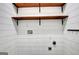 Laundry room featuring wood shelving, shiplap walls, and laundry hook ups at 185 Newfield Dr, Tyrone, GA 30290