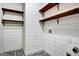 Laundry room features wood shelving and designer tile floor at 185 Newfield Dr, Tyrone, GA 30290