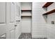 Laundry room featuring dark wood shelves and a decorative tile floor at 185 Newfield Dr, Tyrone, GA 30290