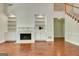 Spacious living room features a fireplace, built-in shelving, and staircase at 185 Newfield Dr, Tyrone, GA 30290