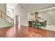 Open floor plan features a staircase, kitchen with breakfast bar, and hardwood floors at 185 Newfield Dr, Tyrone, GA 30290