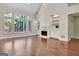 Inviting living room with fireplace, built-in bookcases and large windows at 185 Newfield Dr, Tyrone, GA 30290