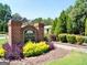 Community sign set in a beautifully landscaped area, creating a welcoming entrance at 185 Newfield Dr, Tyrone, GA 30290