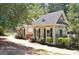 Community pool house with dark shutters and lush landscaping, adding to the neighborhood's charm at 185 Newfield Dr, Tyrone, GA 30290
