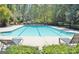 Well-maintained pool with lounge chairs and lush greenery in a community setting at 185 Newfield Dr, Tyrone, GA 30290