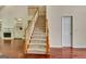 Elegant staircase with carpet runner and wood banister, leading to the upper level at 185 Newfield Dr, Tyrone, GA 30290