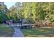 Well-maintained tennis court with surrounding fence and lush greenery at 185 Newfield Dr, Tyrone, GA 30290