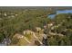 Aerial view of the property at 505 Lighthouse Lane, surrounded by lush trees and a lake at 505 Lighthouse Ln, Peachtree City, GA 30269