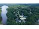 Aerial view of house with pool, golf cart path to lake, shopping and schools at 505 Lighthouse Ln, Peachtree City, GA 30269