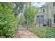 Backyard featuring a stone walkway leading to a gate, and a shed in the background at 505 Lighthouse Ln, Peachtree City, GA 30269