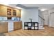 Basement bar area with modern cabinets, sink, small fridge, shelving unit, and stairs to another level at 505 Lighthouse Ln, Peachtree City, GA 30269