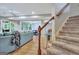 Basement with stairs, a blue couch, and a view of the games area and the outdoor patio with table and chairs at 505 Lighthouse Ln, Peachtree City, GA 30269
