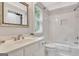 Bright bathroom with white vanity, shower and tub combination, and decorative mirror at 505 Lighthouse Ln, Peachtree City, GA 30269