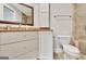 Neutral bathroom vanity area features wood framed mirror, and granite countertops and sink at 505 Lighthouse Ln, Peachtree City, GA 30269